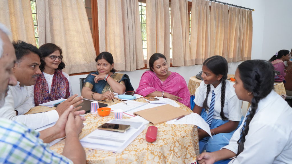  students in conversation with medha employees and government representatives 